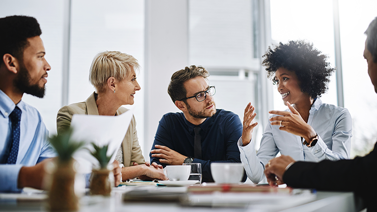 Coworkers sitting at a table having a discussion