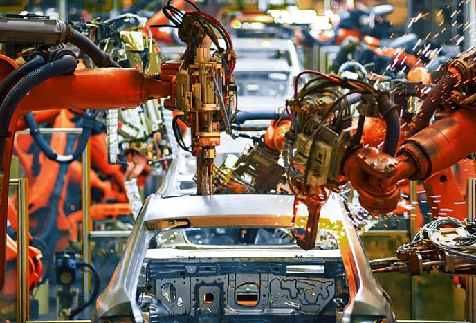 Robots in an assembly line working on vehicles